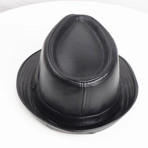 Detail of classic black PU leather fedora showing top indentation and reinforced stitching