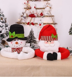 Detail of plush Santa and Snowman long-arm doll decorations on a festive Christmas tree