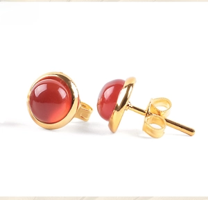 Close-up of gold-plated red agate cabochon earrings with butterfly backs on white background