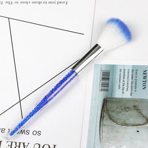 Multifunctional makeup brush with transparent crystal handle and blue-tipped white bristles