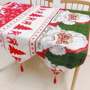 Detail of Christmas table runner featuring jacquard reindeer patterns and red tassels