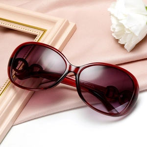 Trendy oversized wine red sunglasses for women with purple gradient lenses on pink silk