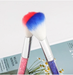 Detail of tapered makeup brushes with crystal-filled handles and tricolor bristles