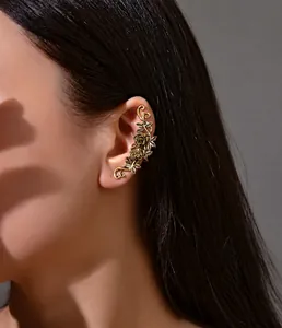 Macro detail of vintage bronze rose relief on a bohemian metal ear cuff earring