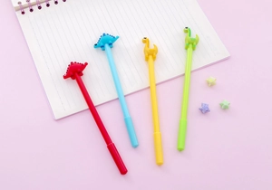 Close-up of four colorful dinosaur gel pens on pink background with origami stars