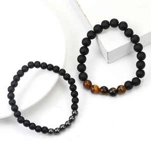 Detailed view of handmade beaded bracelets with matte onyx and natural tiger eye stones