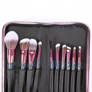Detailed set of 10 professional makeup brushes in a pink glitter storage pouch