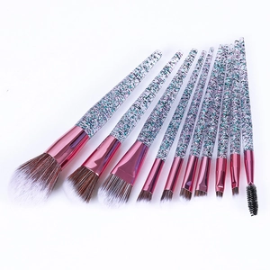Detail of 10-piece eye makeup brush set with purple glitter handles and pink metal tubes
