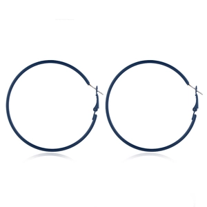 Macro shot of 80s retro neon blue hoop earrings with smooth metallic finish on white