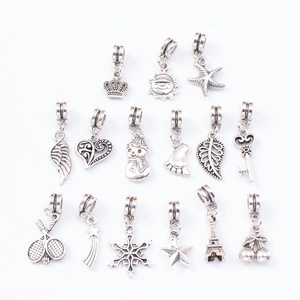 DIY silver charm bracelet kit with crown star and Eiffel Tower pendants on white backdrop