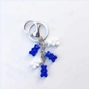 Close-up of candy color resin bears in blue and white on a silver metal keychain