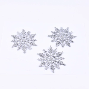 Sparkling silver glitter snowflake ornaments for festive Christmas tree and wall decoration
