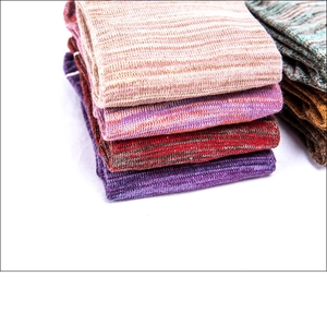 Close-up of thick knit five-toe yoga socks in beige, purple and red cotton blend