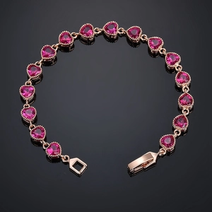Sparkling rose gold heart bracelet with pink AAA cubic zirconia stones on black background