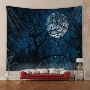 Deep blue moonlit forest tapestry with tree silhouettes hanging above a red sofa