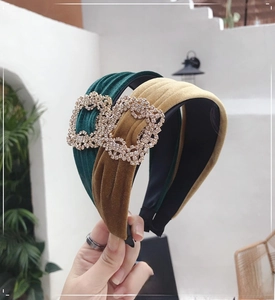 Detail of velvet headbands in green and yellow with sparkling crystal buckles