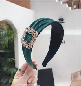 Close-up of luxury velvet headband with sparkling rhinestone rectangle buckle detail