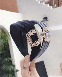 Close-up of velvet padded headbands with sparkling square crystal buckle in black and grey