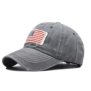 Close-up of distressed grey cotton baseball cap featuring embroidered American flag patch