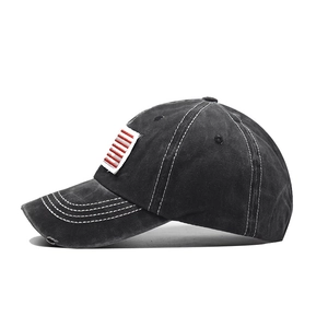 Detail of washed cotton ponytail baseball cap with flag embroidery and frayed edges