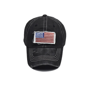 Close-up of black washed cotton baseball cap featuring vintage USA flag embroidery patch