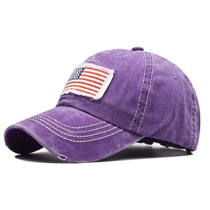 Detail showing distressed cotton fabric and American flag embroidery on purple baseball cap