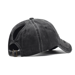 Detail of the ponytail hole and adjustable metal buckle on this washed cotton baseball cap