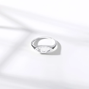 Macro shot of silver bird nest eye-shaped ring with zircon on a clean white background