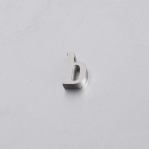Macro view of 10mm silver stainless steel bead shaped like the letter B with matte finish