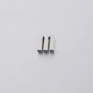 Macro shot of a 10mm polished silver stainless steel letter m bead with mirror finish
