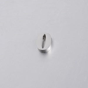 Macro detail of silver mirror-polished stainless steel number 0 letter bead with a top hole
