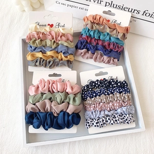 Elegant chiffon scrunchies set in solid colors and polka dots on white card display