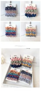 Close-up of assorted chiffon scrunchies in polka dots and solid colors on display cards