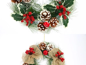 Detail of pine cone Christmas wreath with red berries and burlap bow decoration