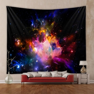 Vibrant galaxy tapestry wall hanging displayed in a modern living room setting