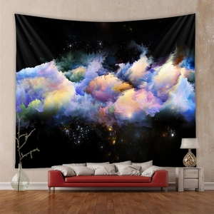 Modern home setting showing a cosmic nebula wall tapestry hanging above a red sofa