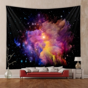 Detailed close-up of a cosmic nebula tapestry hanging above a red sofa in a room