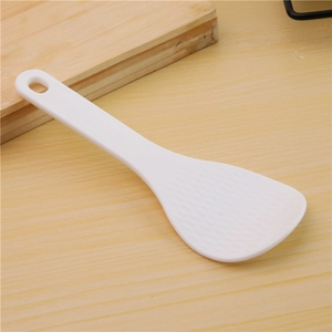 DIY sushi ball maker mold with white non-stick rice paddle on wooden table