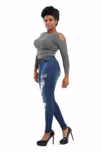 Close-up of slim fit denim jeans with ripped holes and leopard print patches