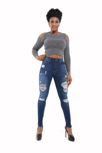 Close-up of blue distressed skinny jeans with ripped details and tight fit style