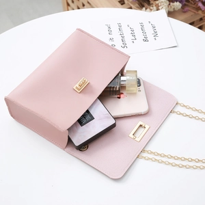 Pink PU leather phone bag with gold chain strap and turn-lock shown from a top view