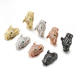 Detailed view of micro-paved leopard head pendants in gold, silver, and rose gold finishes