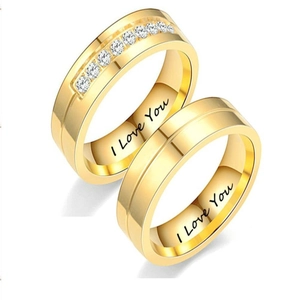 Macro view of gold couple rings with small diamonds and I Love You inner engraving