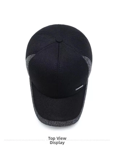 Bird's eye view of a wool baseball cap with grey fabric patchwork and silver plaque