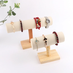 Detail of wooden jewelry display stand with beige velvet T-bar for bracelets and watches