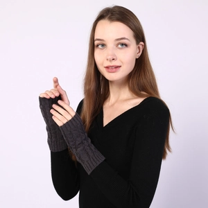 Detailed close-up of dark grey cable knit fingerless gloves showing premium texture