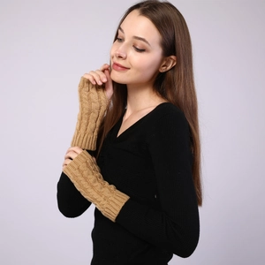 Detail of cable knit texture on camel fingerless arm warmers for winter style
