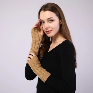 Macro view of cable knit pattern on camel-colored fingerless warm arm sleeves