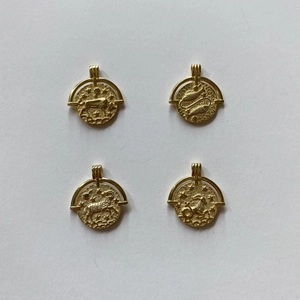 Detailed view of 925 silver gold-plated zodiac relief coins with constellation patterns