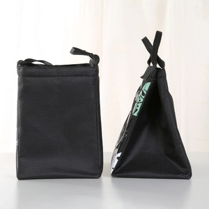 Detail of insulated lunch bag with cartoon cat print and black canvas trapezoid structure